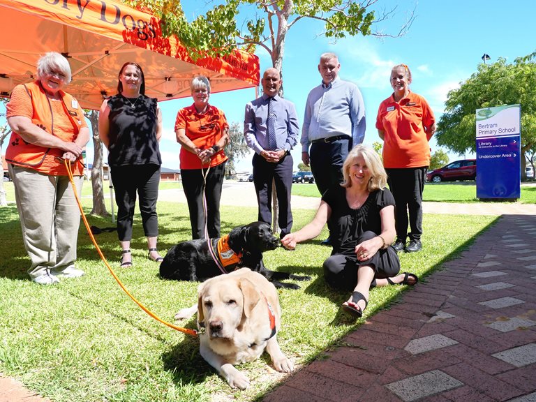 Mayor Carol Adams with a Story Dogs volunteer and her dog.