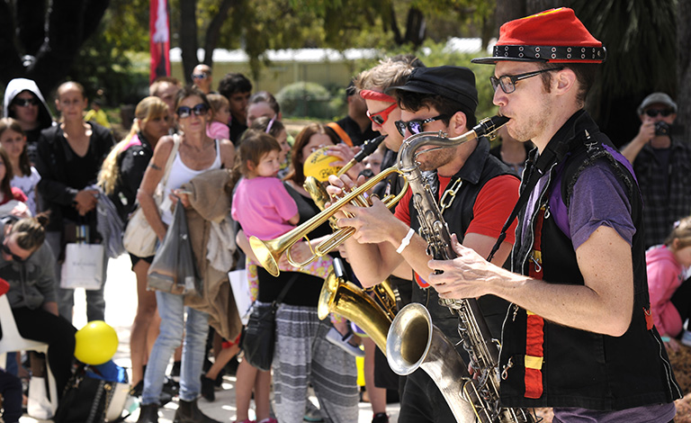 A band plays while onlookers watch.