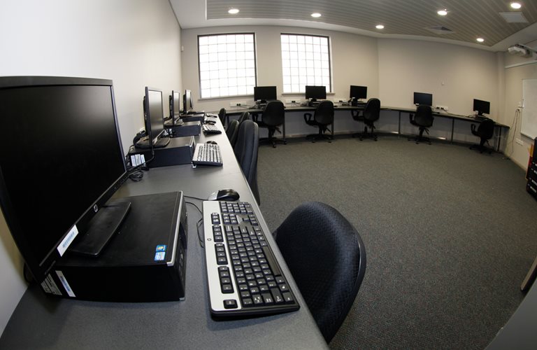 A look at Zone Youth Space's Multimedia Room, with several computers set up.