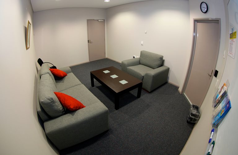 An image of one of the Zone Offices/Counselling Rooms, with a couch and an armchair.