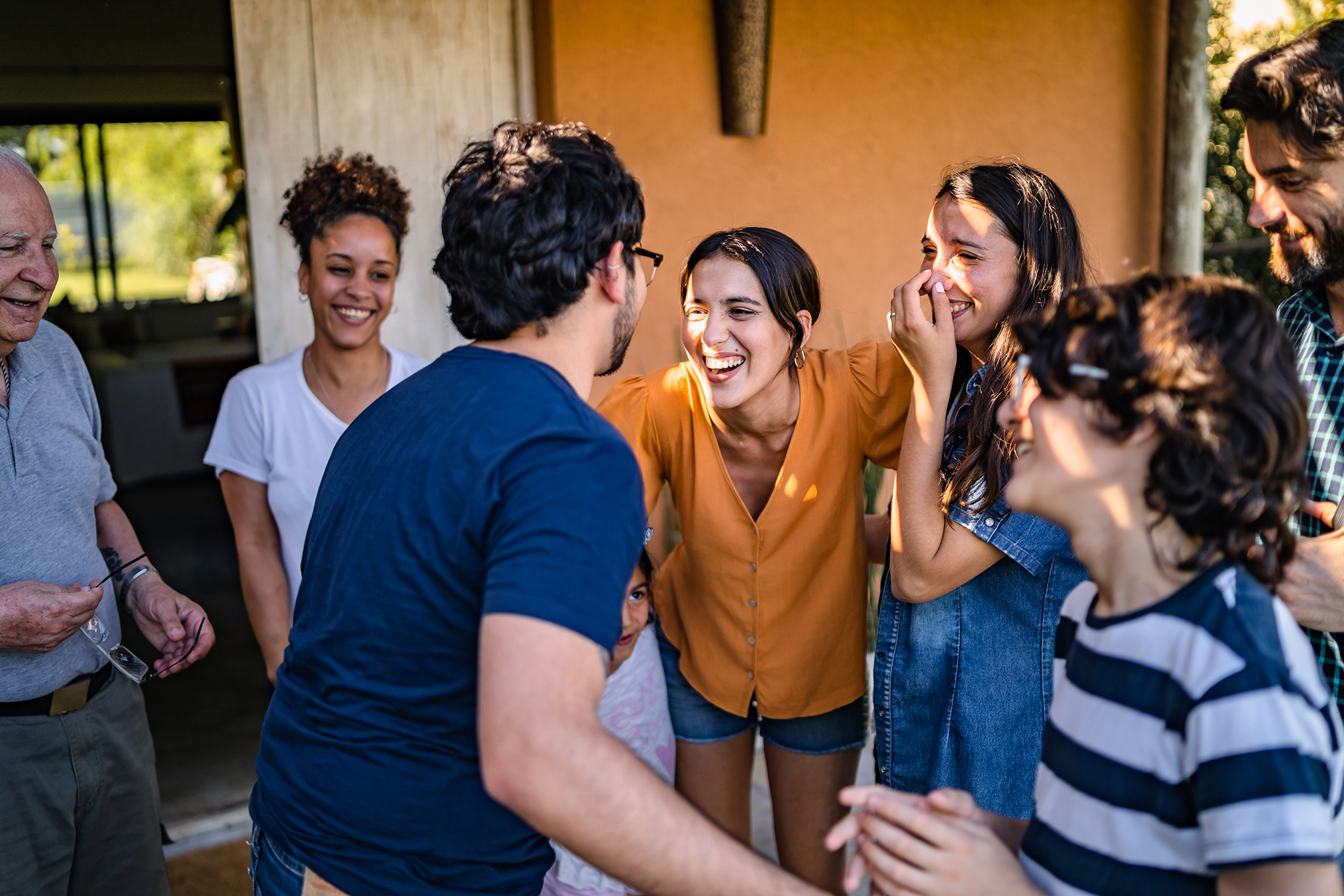 A family gathering with a group of people standing together outdoors.