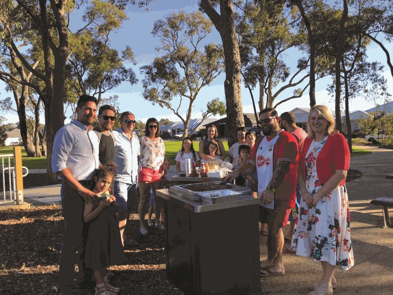 Carol Adams stands with a group barbecuing at a local park.