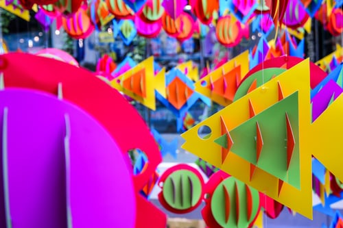 Colourful paper fish hanging in a display.