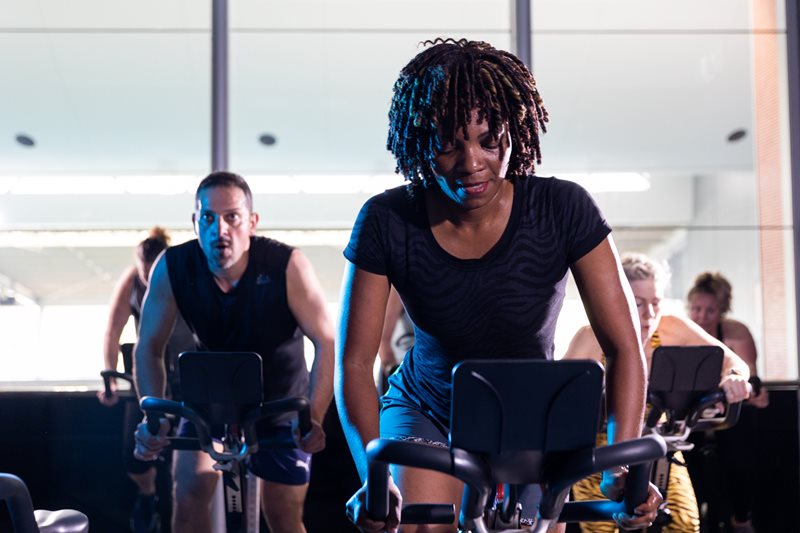 Male and female doing a spin class