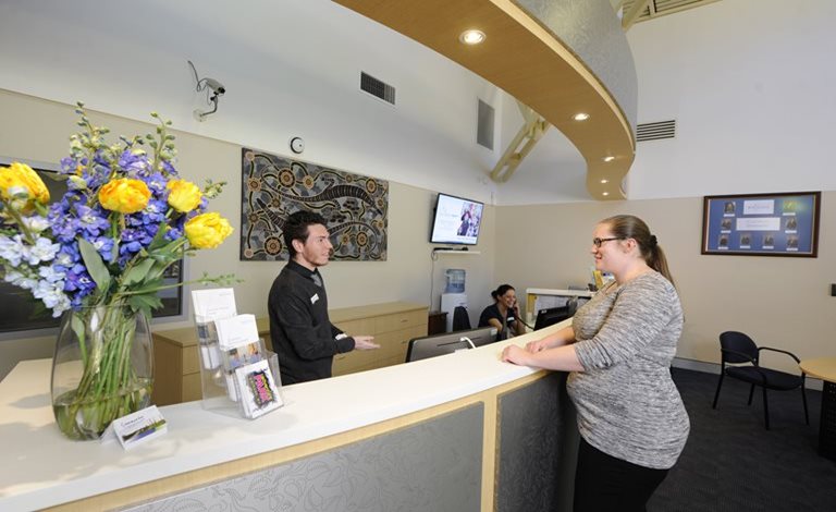 A resident speaks to a Customer Service Officer in Reception